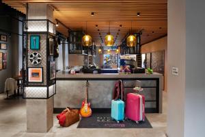 a counter with two suitcases on display in a kitchen at Moxy Manchester City in Manchester