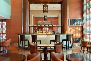 a bar in a restaurant with chairs and tables at Four Points By Sheraton Le Verdun in Beirut