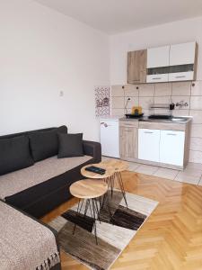 a living room with a couch and a table at Apartman HeLena in Soko Banja