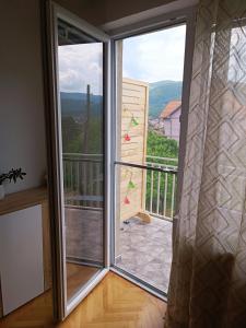a sliding glass door with a view of a balcony at Apartman HeLena in Soko Banja