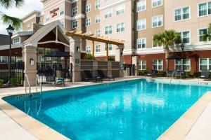 a swimming pool in front of a building at Residence Inn Gainesville I-75 in Gainesville