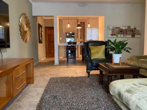 a living room with a couch and a chair at Endonini House in Nelspruit