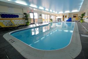 a large swimming pool in a large building at Fairfield Inn & Suites by Marriott Bowling Green in Bowling Green