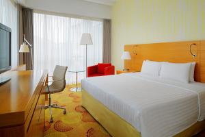 a hotel room with a large bed and a desk at Courtyard by Marriott Budapest City Center in Budapest