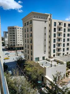 Blick auf ein großes weißes Gebäude in einer Stadt in der Unterkunft luxe & VIP appartement a côté de tunsia mall lac 2 in Tunis