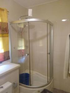 a shower with a glass door in a bathroom at Spintex Villas - Available for Long Term Rentals in Ablekuma