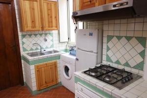 a small kitchen with a stove and a sink at Il Portale 2 in Tropea +9 photos