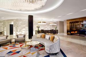 a living room with a couch and a chandelier at The Alexander, a Luxury Collection Hotel, Yerevan in Yerevan