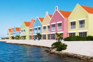 a row of colorful houses next to the water at Courtyard by Marriott Bonaire Dive Resort in Kralendijk