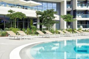 a swimming pool in front of a building at Sheraton Dubrovnik Riviera Hotel in Mlini