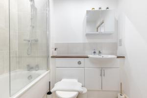 a bathroom with a toilet and a sink and a shower at Right Place in London
