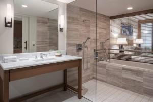 a bathroom with a sink and a shower at The Ritz-Carlton Residences, Waikiki Beach Hotel in Honolulu