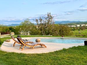 two lounge chairs and a pool in a yard at The Borum House in Cholakovtsi