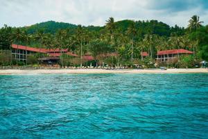 a view of a beach with palm trees and a resort at Sheraton Senggigi Beach Resort in Senggigi