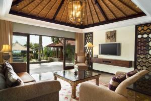 a living room with a couch and a tv at Sheraton Senggigi Beach Resort in Senggigi