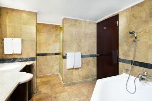 a bathroom with two sinks and a shower at Sheraton Senggigi Beach Resort in Senggigi