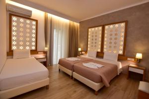 Postel nebo postele na pokoji v ubytování Hotel Aghas Paleochora