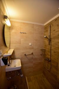 a bathroom with a sink and a shower at Hotel Aghas Paleochora in Palaiochora