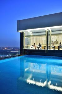 a building with a swimming pool in front of it at Renaissance Lucknow Hotel in Lucknow