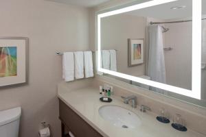 a bathroom with a sink and a mirror at Sheraton Dallas Hotel by the Galleria in Dallas
