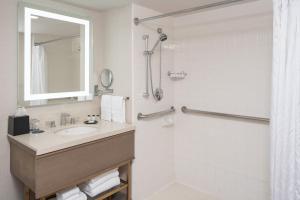 a bathroom with a sink and a shower at Sheraton Dallas Hotel by the Galleria in Dallas