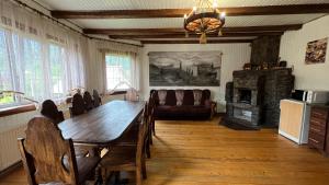 a dining room with a table and a couch at Arkan in Mykulychyn