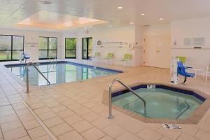 a pool in a hospital with a waiting room with chairs at Courtyard Charlotte Gastonia in Gastonia