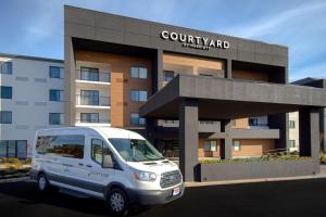 a white van parked in front of a building at Courtyard by Marriott Cincinnati Airport in Erlanger