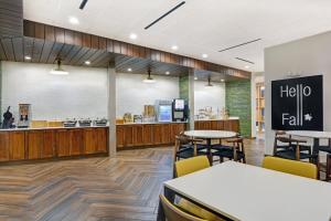 a restaurant with tables and chairs and a hello fall counter at Fairfield Inn & Suites by Marriott Houston NASA/Webster in Webster