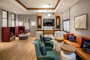 a living room with a couch and chairs and a table at Sheraton Nashua in Nashua