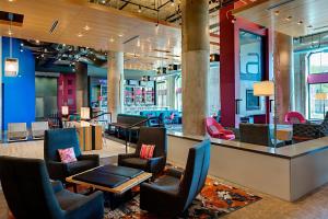 a lobby of a store with chairs and a table at Aloft Dallas Downtown in Dallas