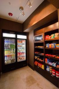 a store aisle with two refrigerators and lots of food at Fairfield Inn and Suites by Marriott North Spring in Spring