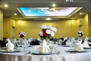 a table set up for a banquet with white and red flowers at Fairfield Inn and Suites by Marriott North Spring in Spring