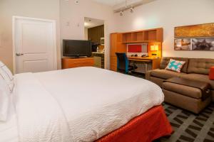 a bedroom with a bed and a couch and a desk at TownePlace Suites by Marriott Baton Rouge Gonzales in Gonzales