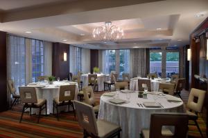 a conference room with tables and chairs and a chandelier at Ellis Hotel, Atlanta, a Tribute Portfolio Hotel in Atlanta