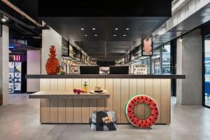 a restaurant with a counter and a donut seat at Moxy La Ciotat in La Ciotat +37 photos