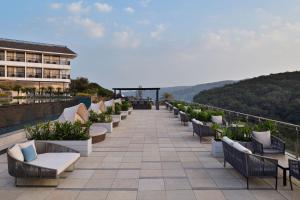 a row of chairs on the roof of a building at Courtyard by Marriott Mahabaleshwar in Mahabaleshwar