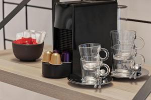 a shelf with a coffee maker and glasses on it at Moxy La Ciotat in La Ciotat