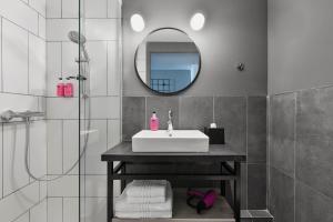 a bathroom with a sink and a mirror at Moxy La Ciotat in La Ciotat