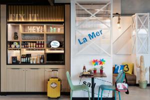 a restaurant with a table and chairs in a room at Moxy La Ciotat in La Ciotat