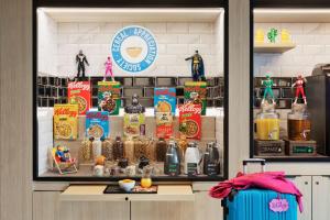 a display case in a coffee shop with food items at Moxy La Ciotat in La Ciotat