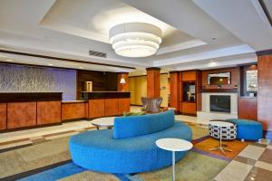 a lobby with a blue couch and a table at Fairfield Inn and Suites by Marriott Birmingham Fultondale / I-65 in Fultondale