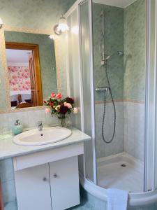 a bathroom with a shower and a sink and a shower at Villa Peonia in Keszthely