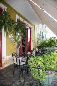 a patio with chairs and a table and plants at Petania Hotel & Apartments in Lixouri