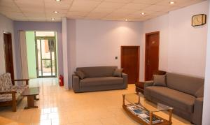 a living room with two couches and a table at Petania Hotel & Apartments in Lixouri