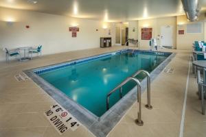 a large swimming pool in a building at TownePlace Suites by Marriott Milwaukee Oak Creek in Oak Creek