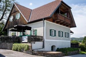 a house with a wooden roof at Schilcherland Lodge in Greisdorf