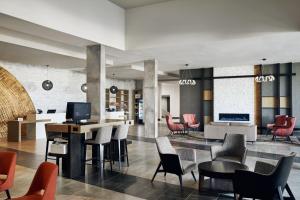 a lobby with chairs and a table and a couch at Chicago Marriott Oak Brook in Oak Brook