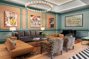 a living room with a couch and a table and chairs at The Memphian a Tribute Portfolio Hotel in Memphis