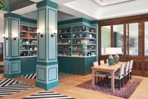 a dining room with green cabinets and a table at The Memphian a Tribute Portfolio Hotel in Memphis